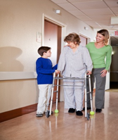 Person using a walker, photo source:  walker with tennis balls istockphoto 00001924470