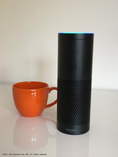 Amazon Echo (Alexa) next to large coffee cup for size comparison